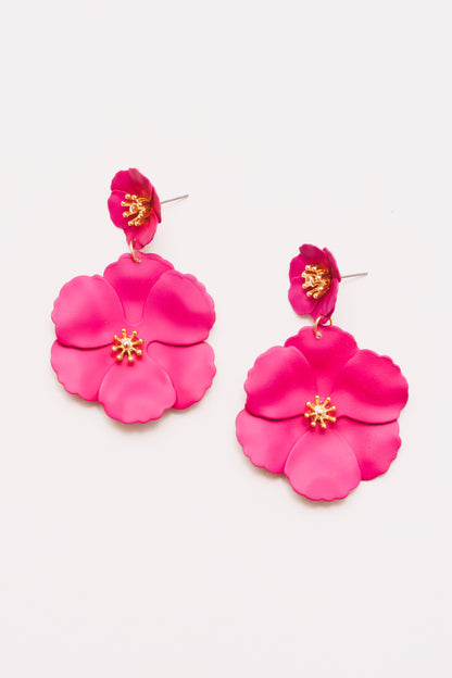 Close-up of bright pink enamel flower drop earrings