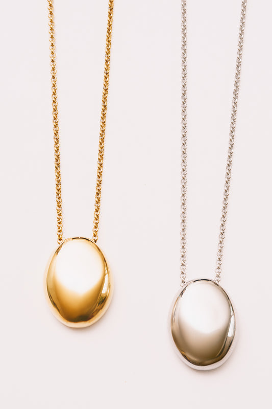 minimal necklace for women shown in gold and silver pendants with mirror finish