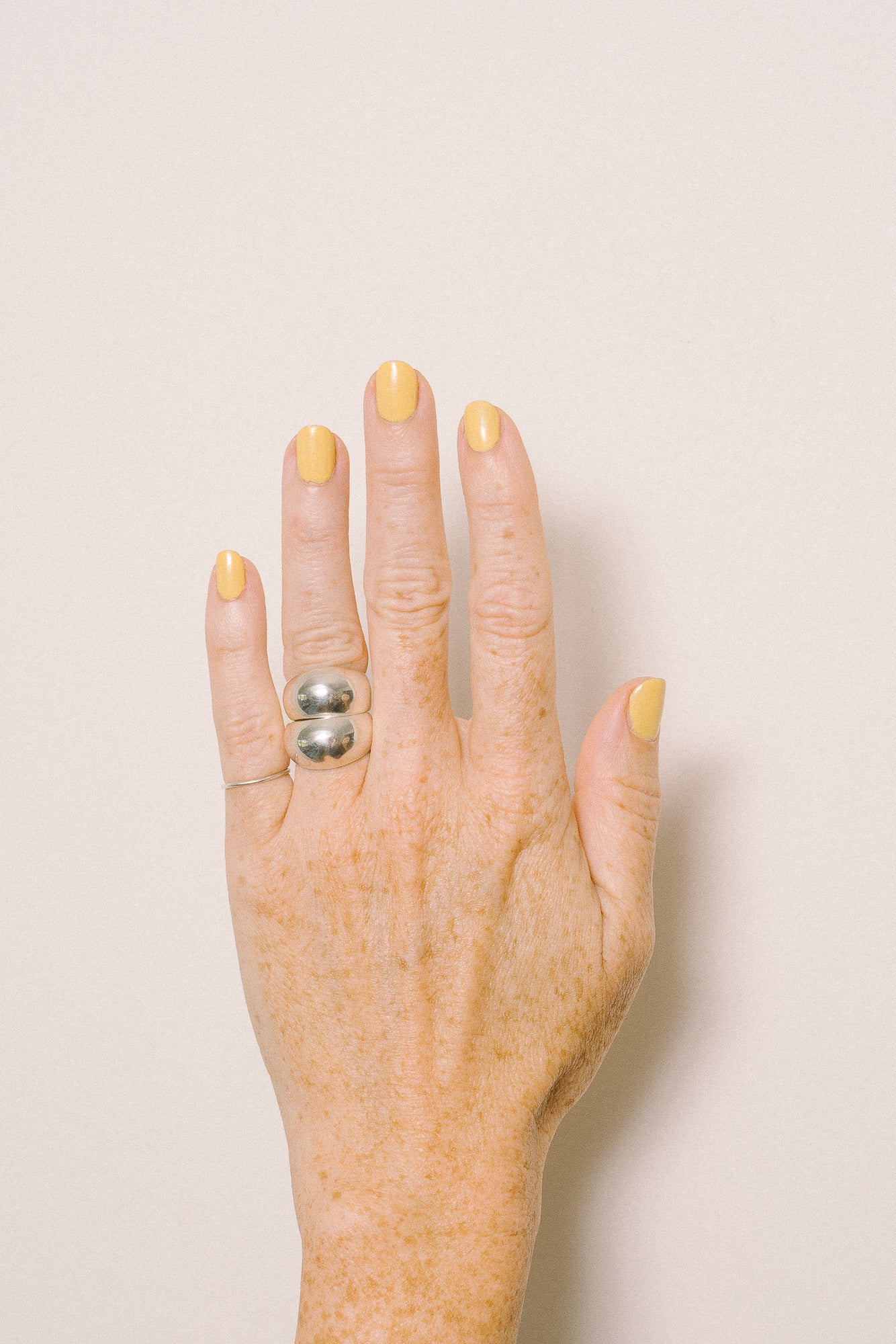 stacked silver dome rings on model hand