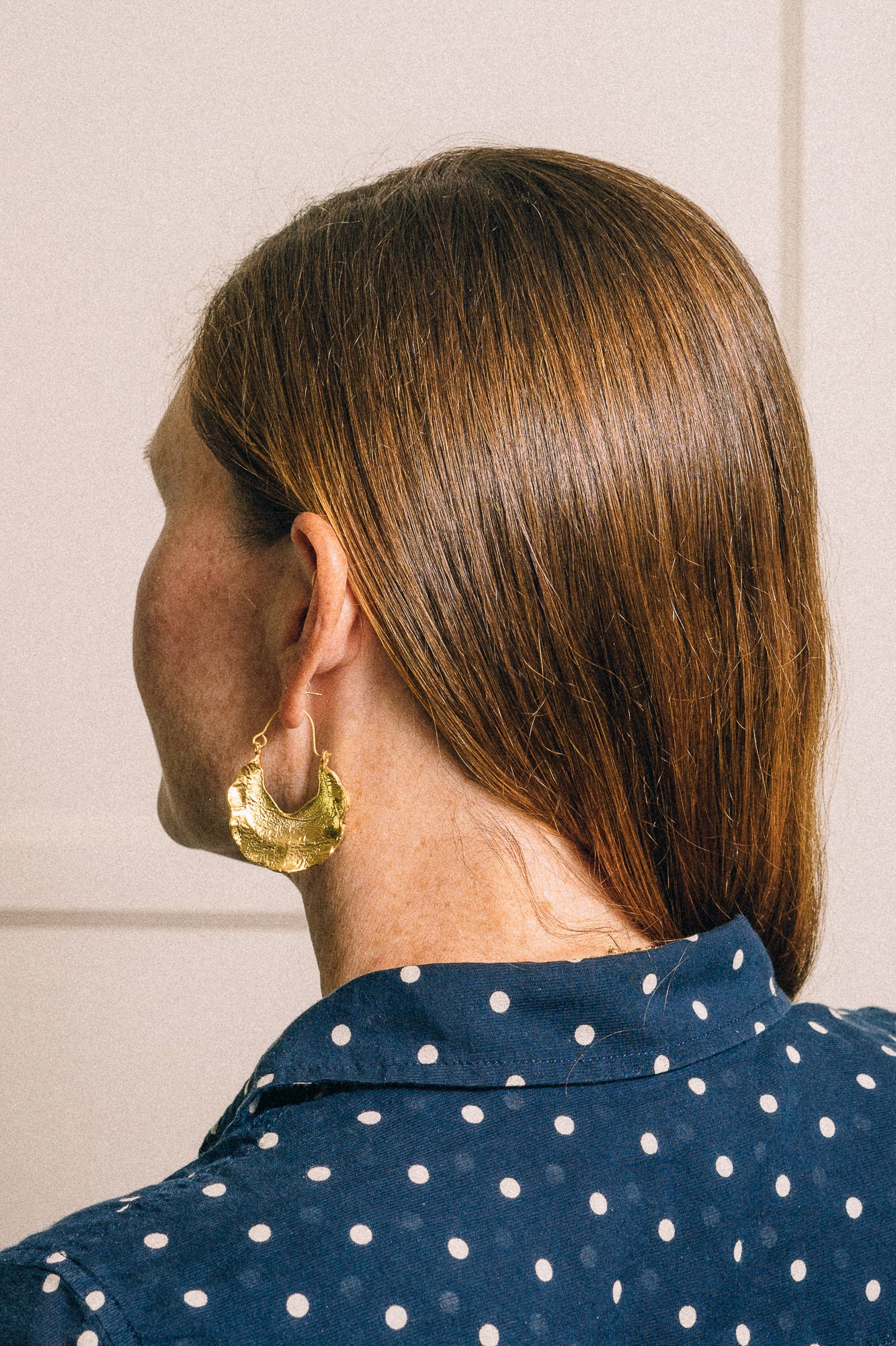 gold hoop earrings on model side back view