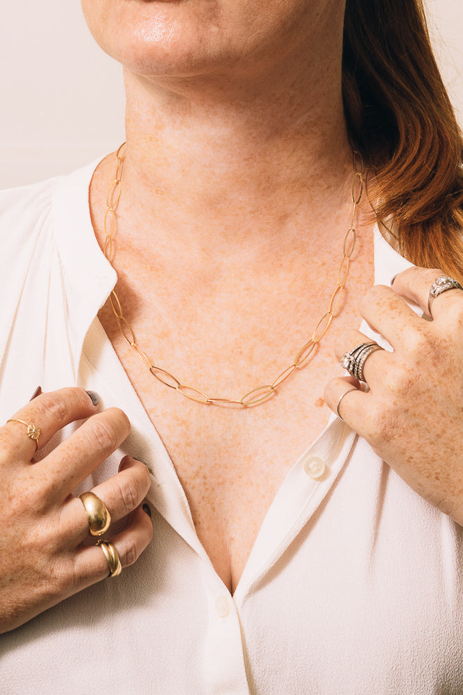 gold paperclip mask chain necklace on model
