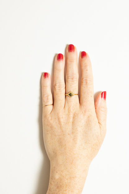 gold triangle stacking ring and pinkie ring on model hand