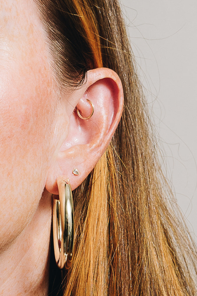 gold chunky hoops on model closeup