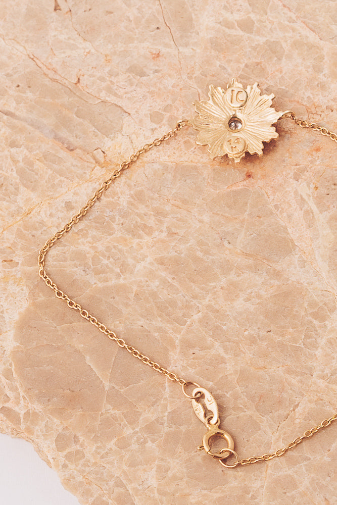gold starburst charm bracelet back view closeup of clasp and charm