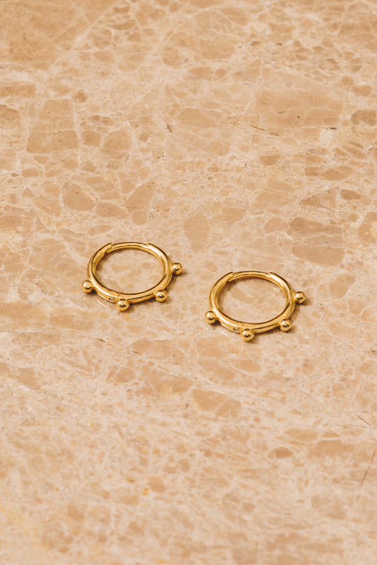 gold huggie hoop earrings with gold ball accents