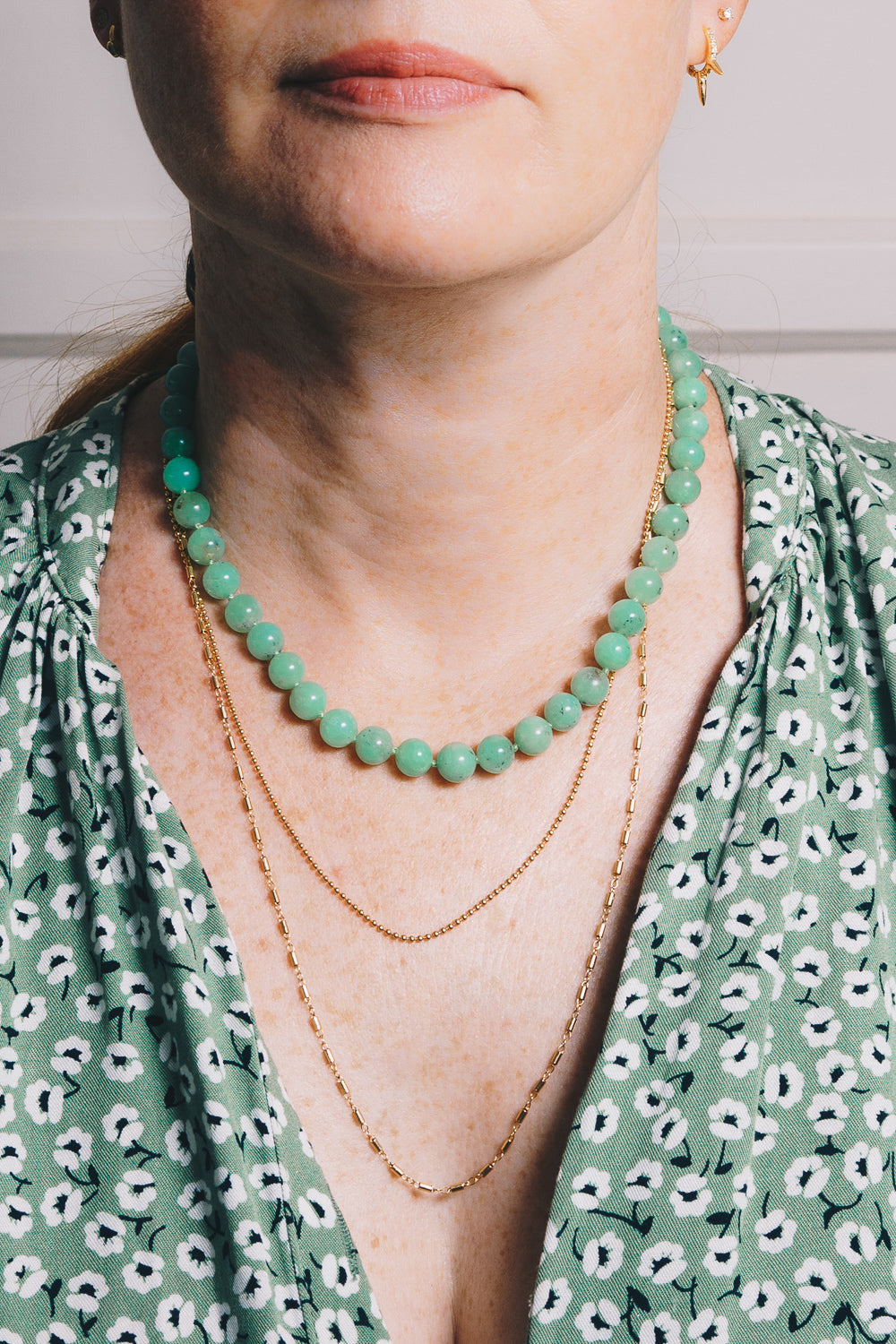 chrysoprase strung bead necklace with layering necklaces on model