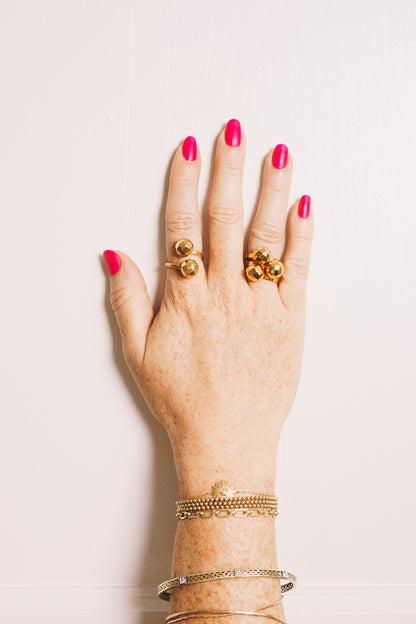 gold ball stacking rings on model hand