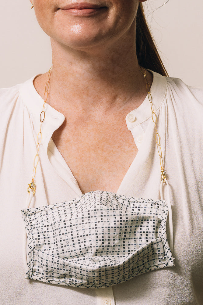 gold paperclip chain mask holder on model