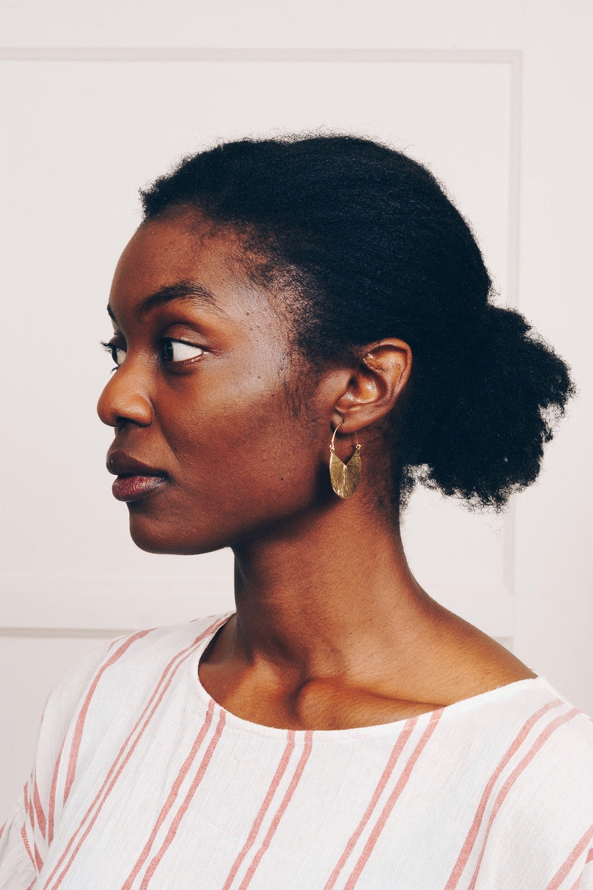 gold hoop earrings on model side view