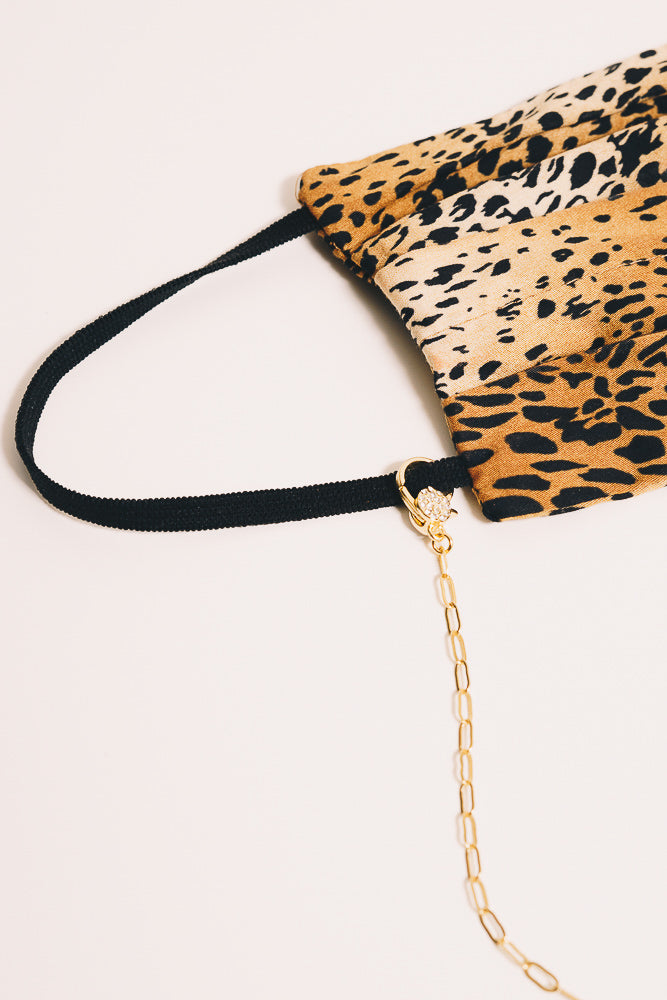 gold mask chain necklace closeup