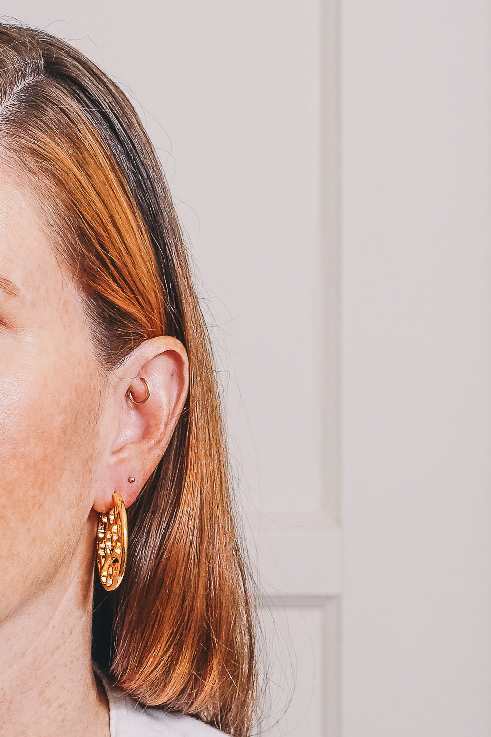 cutout gold hoop earrings on model