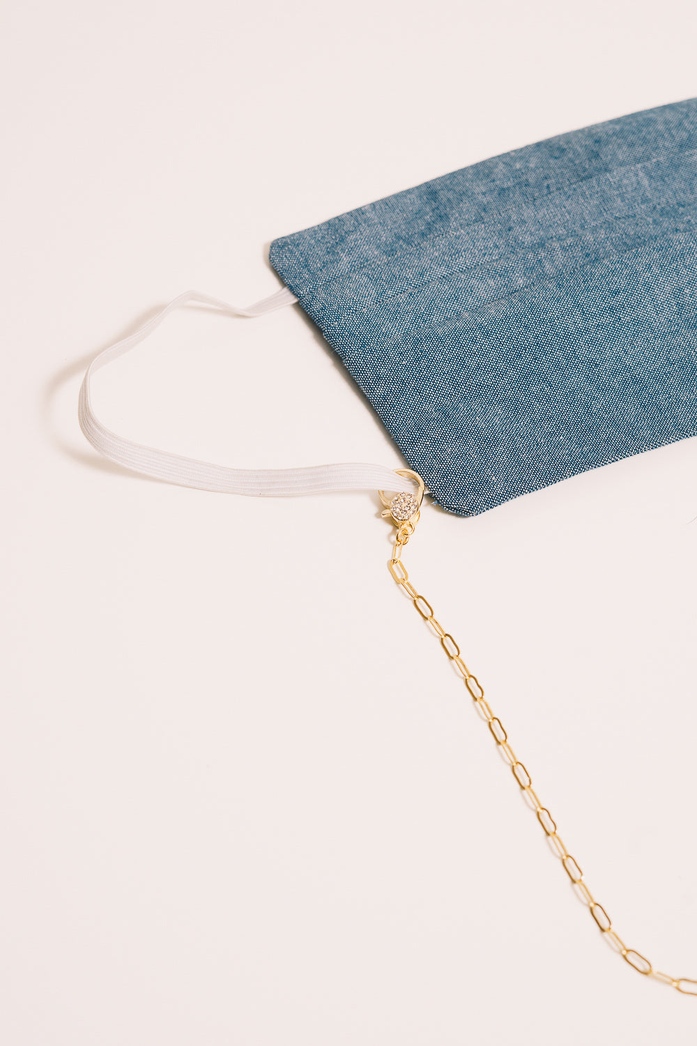 gold chain necklace with mask closeup