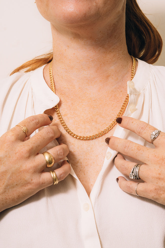 gold curb chain necklace on model