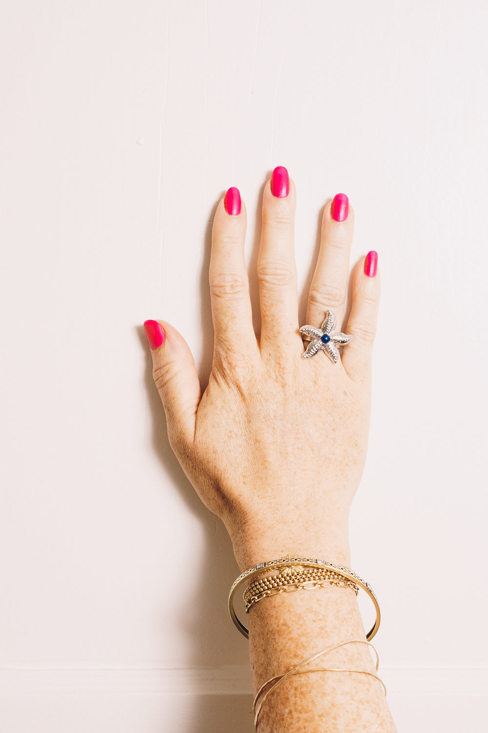 silver starfish ring with lapis cabochon on model hand