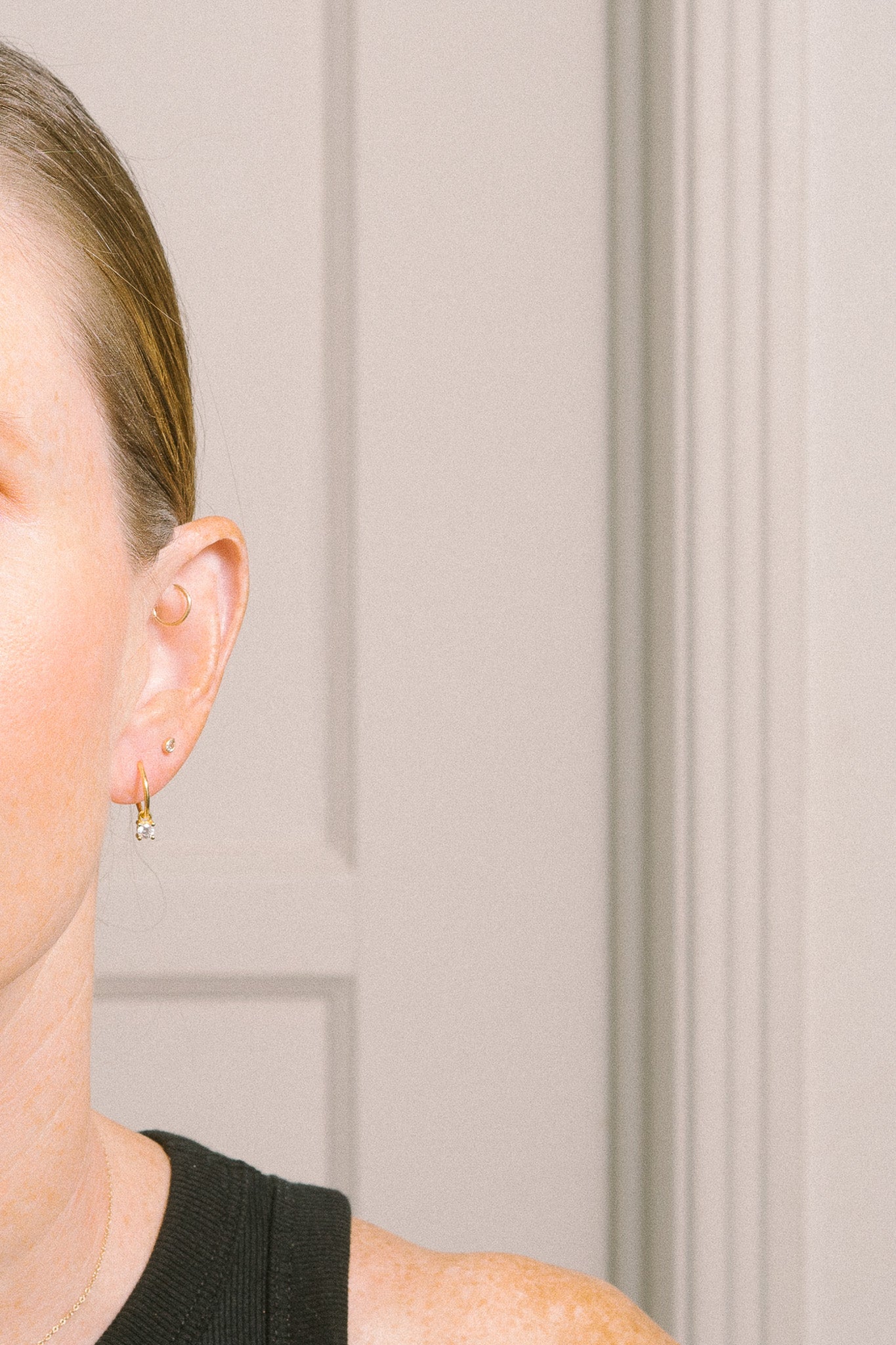 minimal small gold hoops with crystal dangles on model