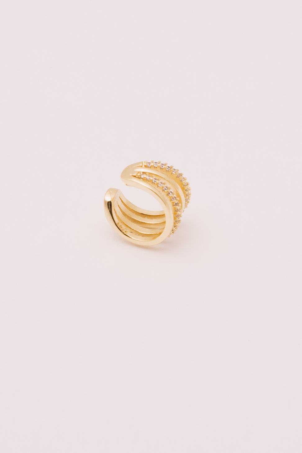 gold and crystal multi strand ear cuff on white background