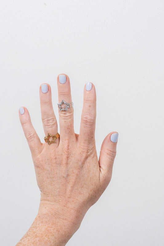 gold and silver star rings on hand