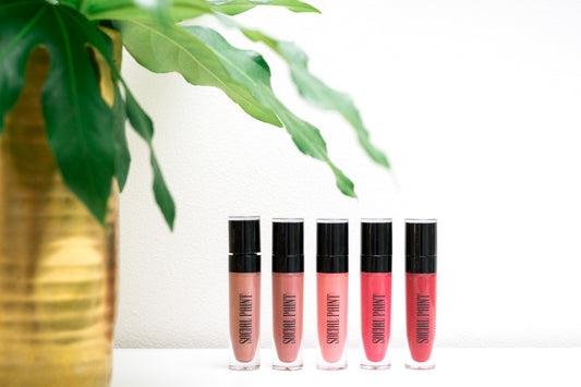 lipsticks by social paint standing up with green plant vase