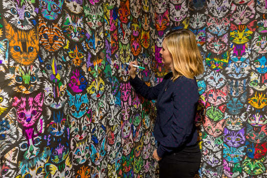 Janna Conner drawing on Tim Andrews rainbow kitten wall at the other art show in dtla