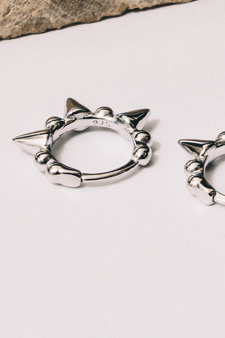 silver spike huggie earrings closeup