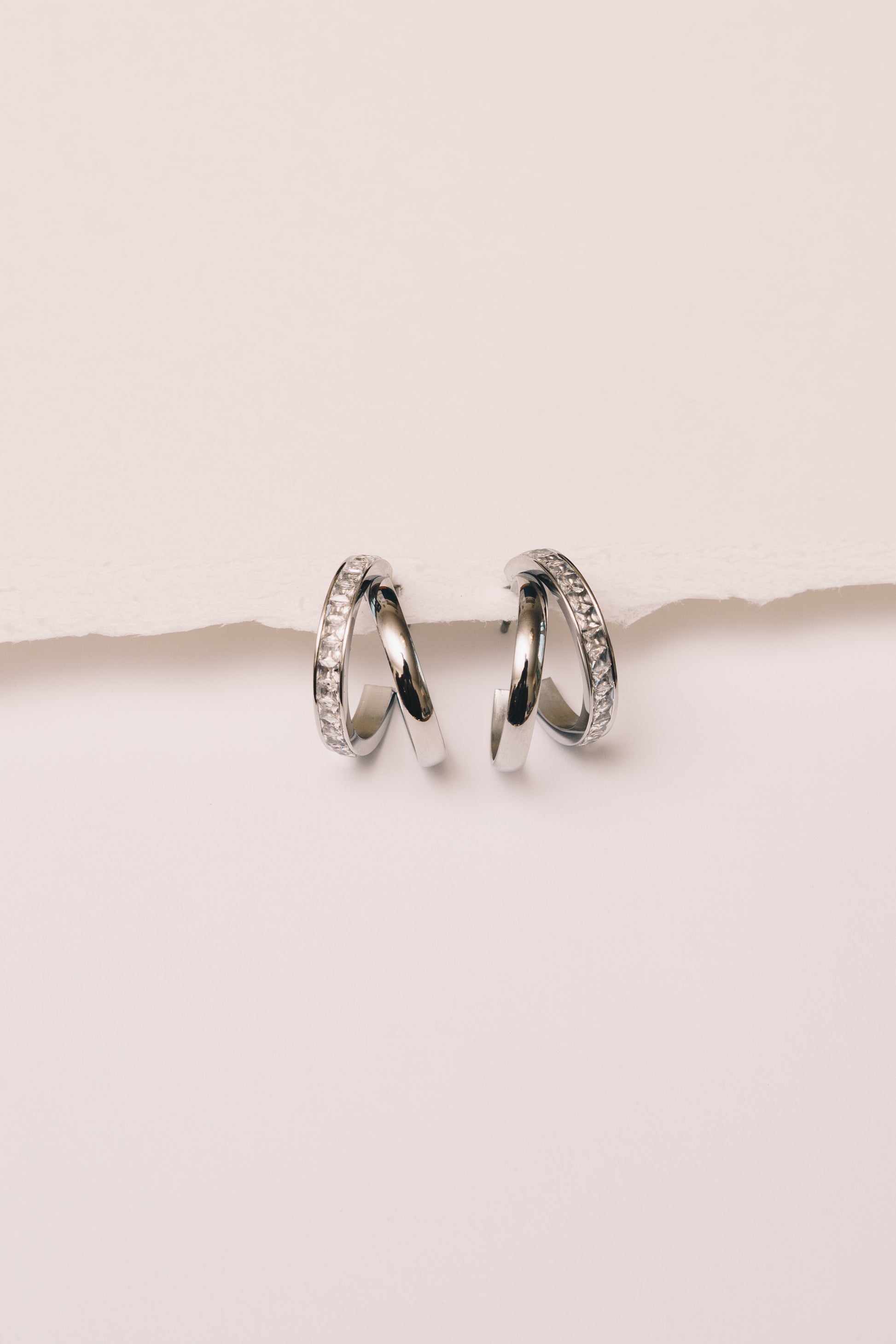 split hoop crystal earrings on white background