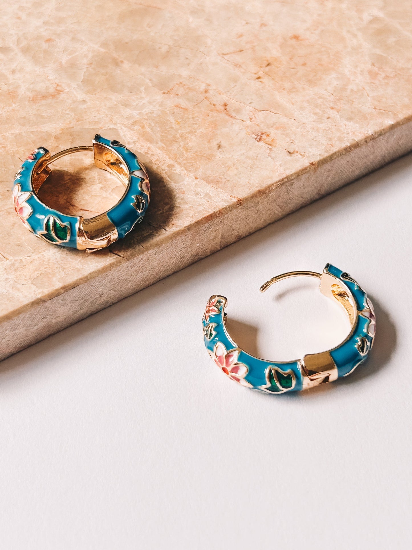 blue cloisonné hoop earrings one open one closed 