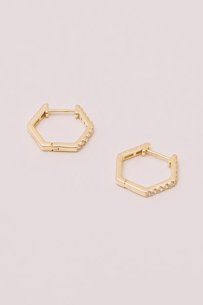 gold hexagon Huggies on white background closeup