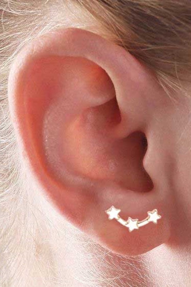 gold star constellation earring on ear
