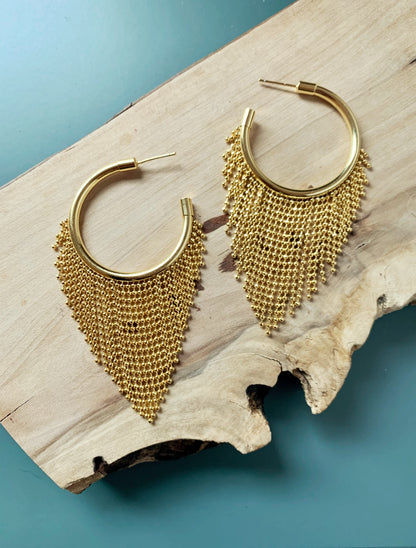 gold ball chain fringe hoop earrings on reclaimed wood panel