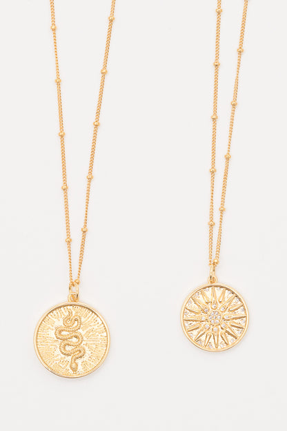 gold layering necklaces with snake charm and starburst charm pendants