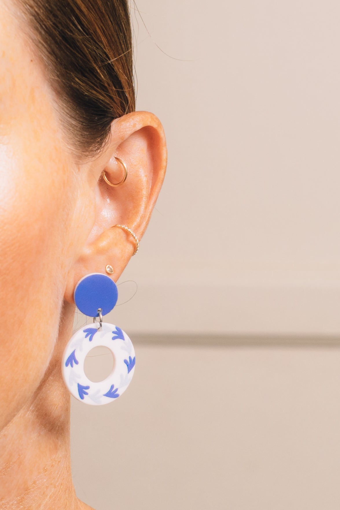 blue and white dangle earrings on model 