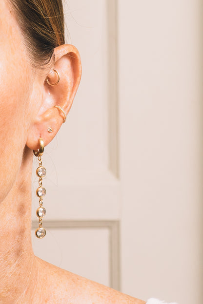 crystal dangle huggie hoop earrings on model