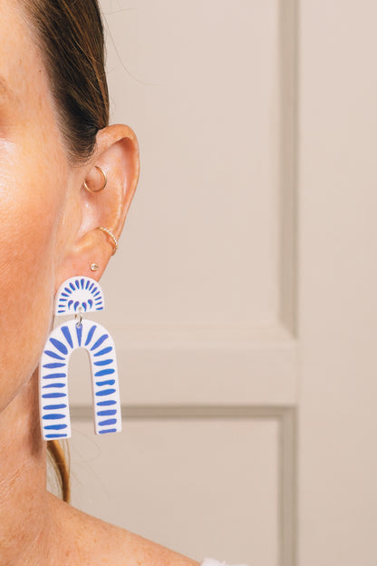 blue and white drop earrings on model