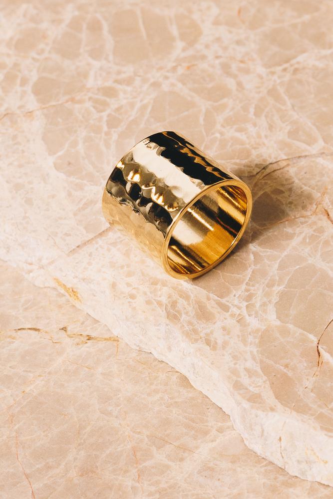 18K Gold plated cigar band ring on beige marble