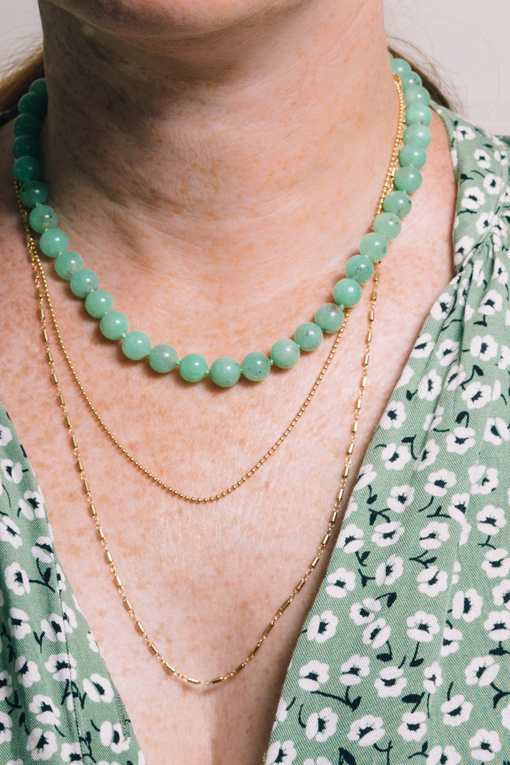 chrysoprase strung bead necklace with layering necklaces on model
