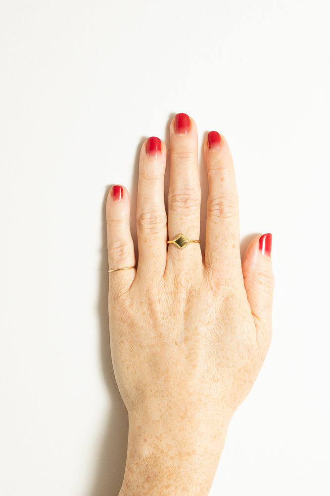 gold triangle stacking ring and pinkie ring on model hand