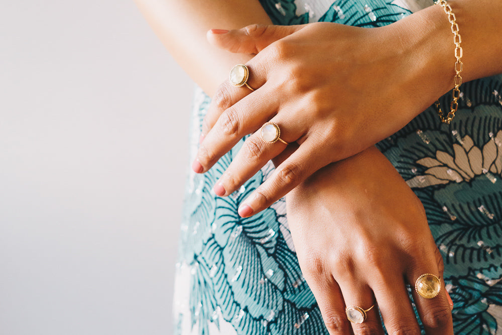 hands overlapping with rings and vintage chain link bracelet