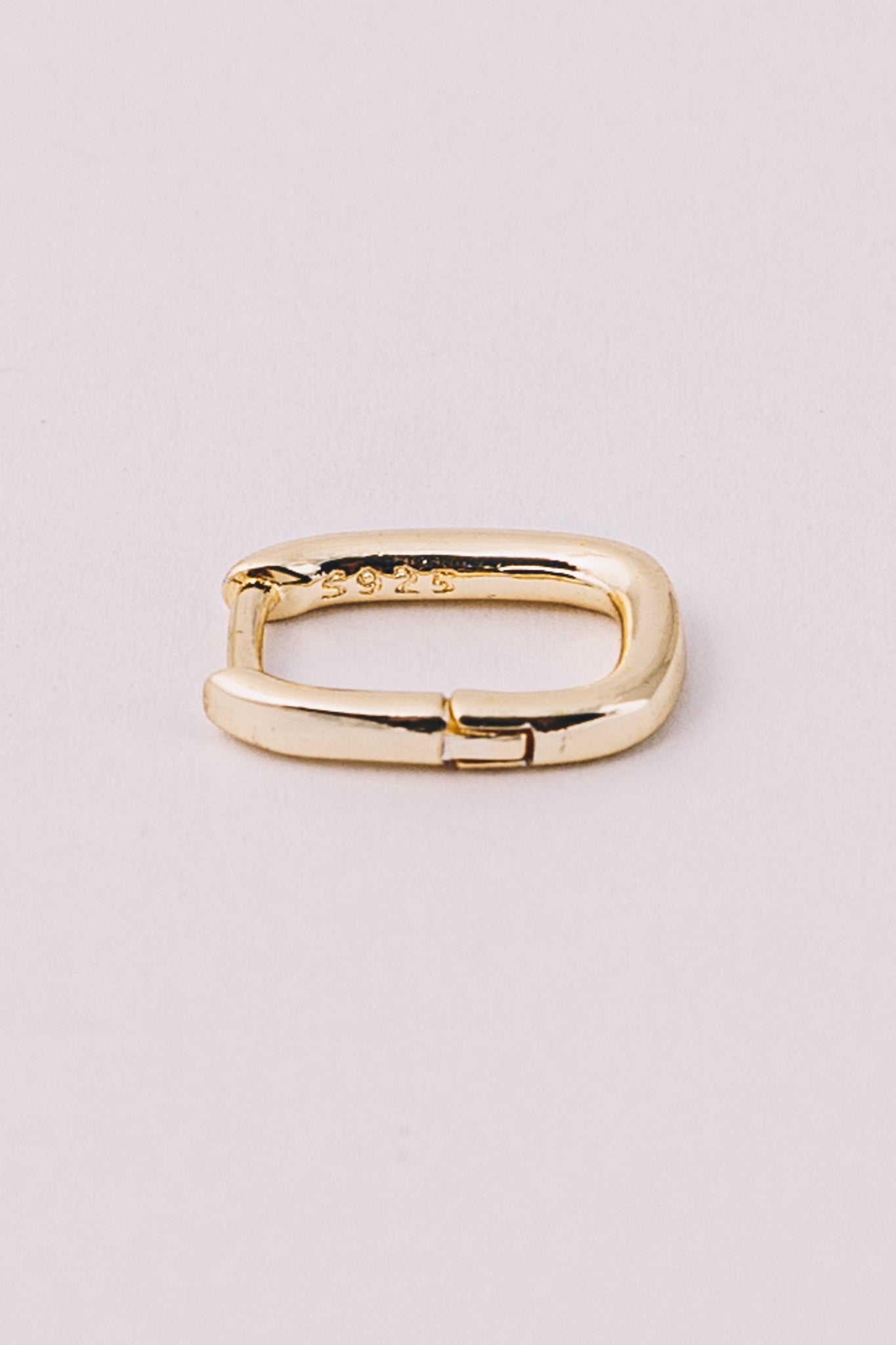gold huggie hoop earring closeup