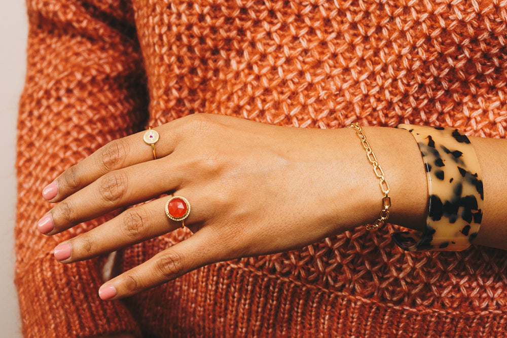 chain link bracelet on model with stacking rings and acrylic cuff bracelet