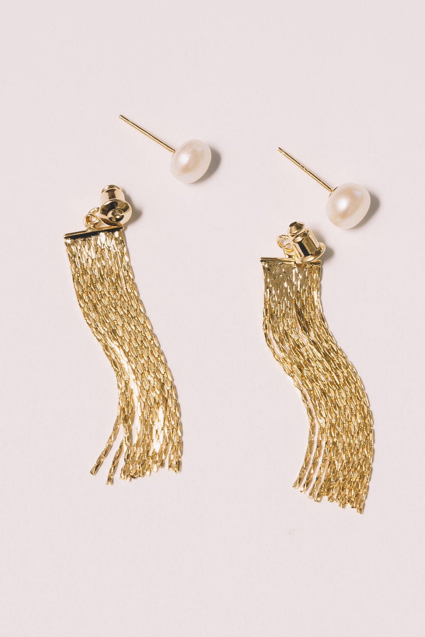 pearl studs with gold tassel ear jackets closeup