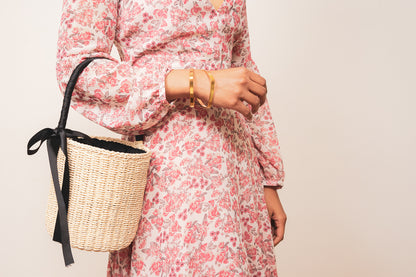 gold square bangle bracelet set on model with straw bag