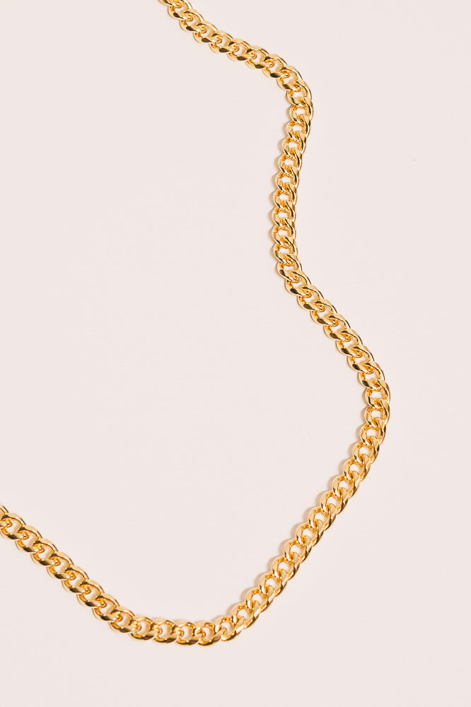 gold curb chain necklace closeup