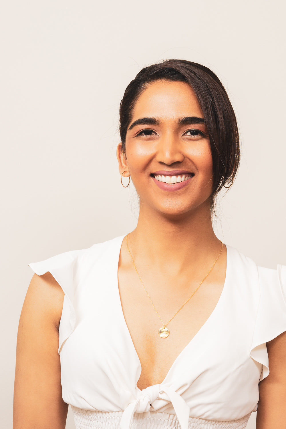 gold endless hoop earrings on model