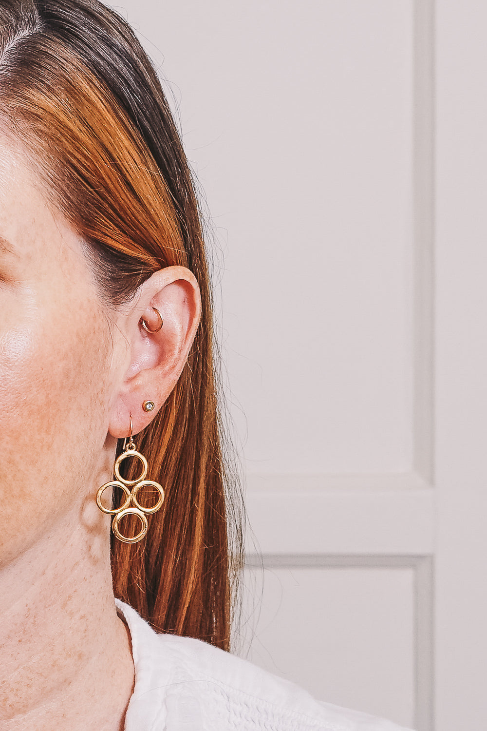 gold circle dangle earrings on model