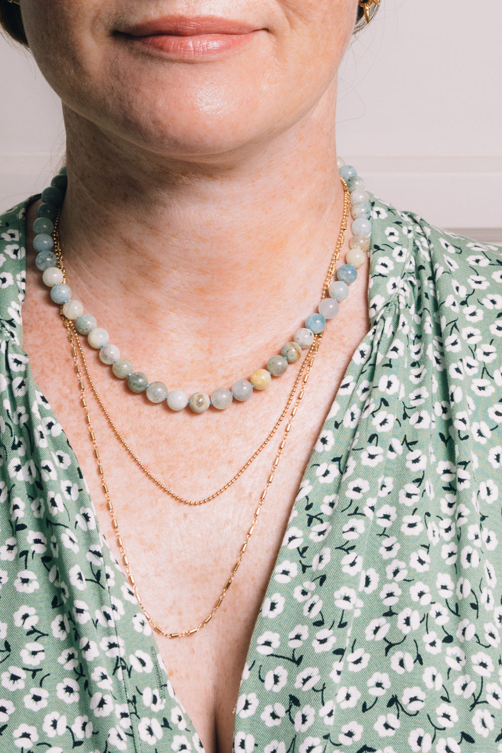 aquamarine beaded necklace with layering necklaces on model