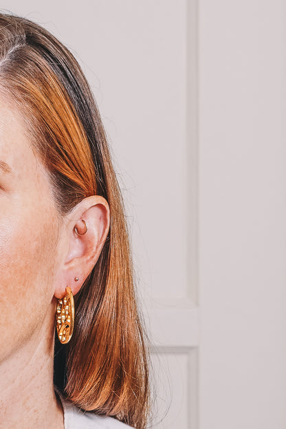 cutout gold hoop earrings on model