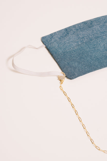 gold chain necklace with mask closeup