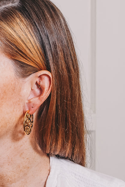 cutout hoop earrings on model sideview