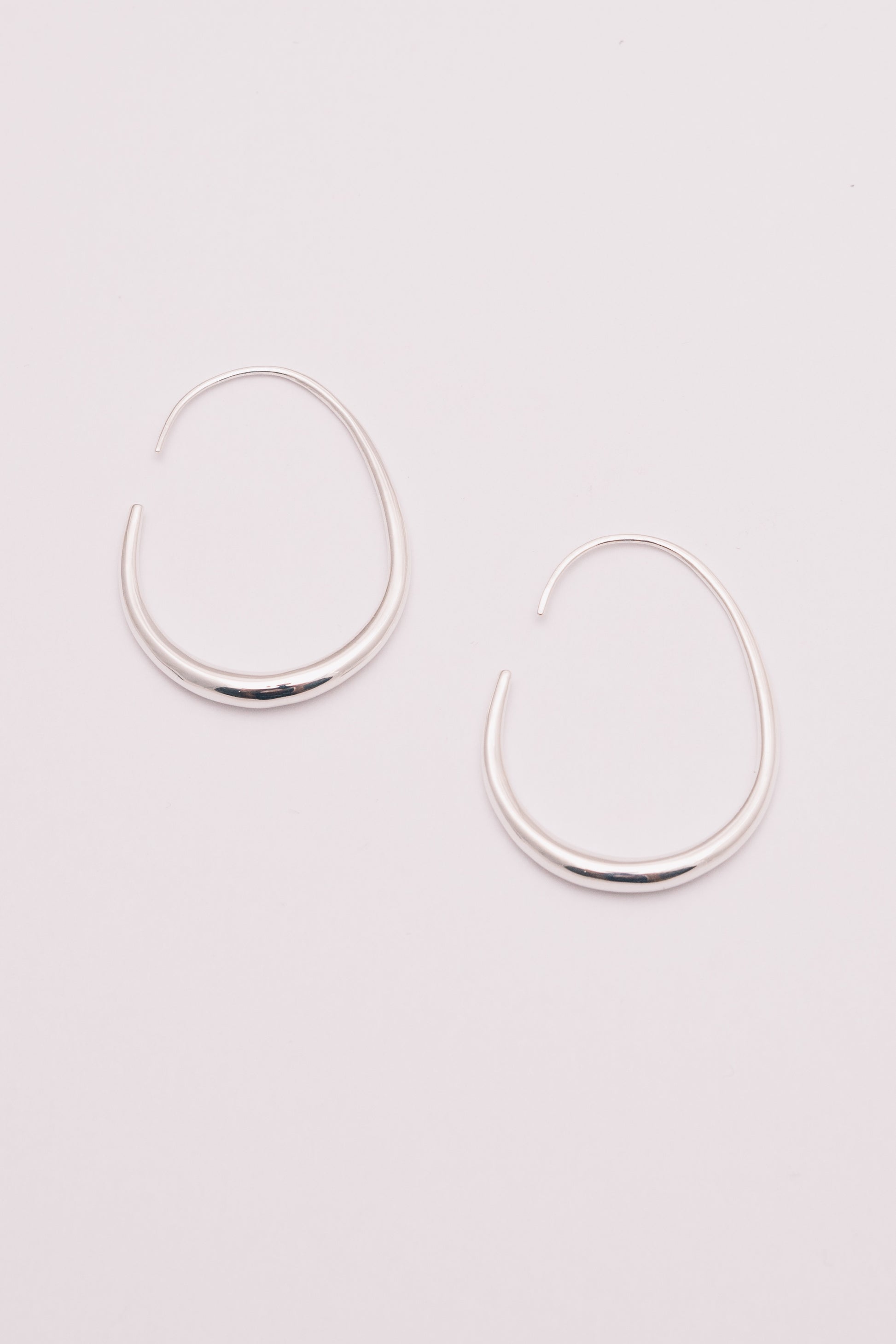 silver threader hoop earrings on white background