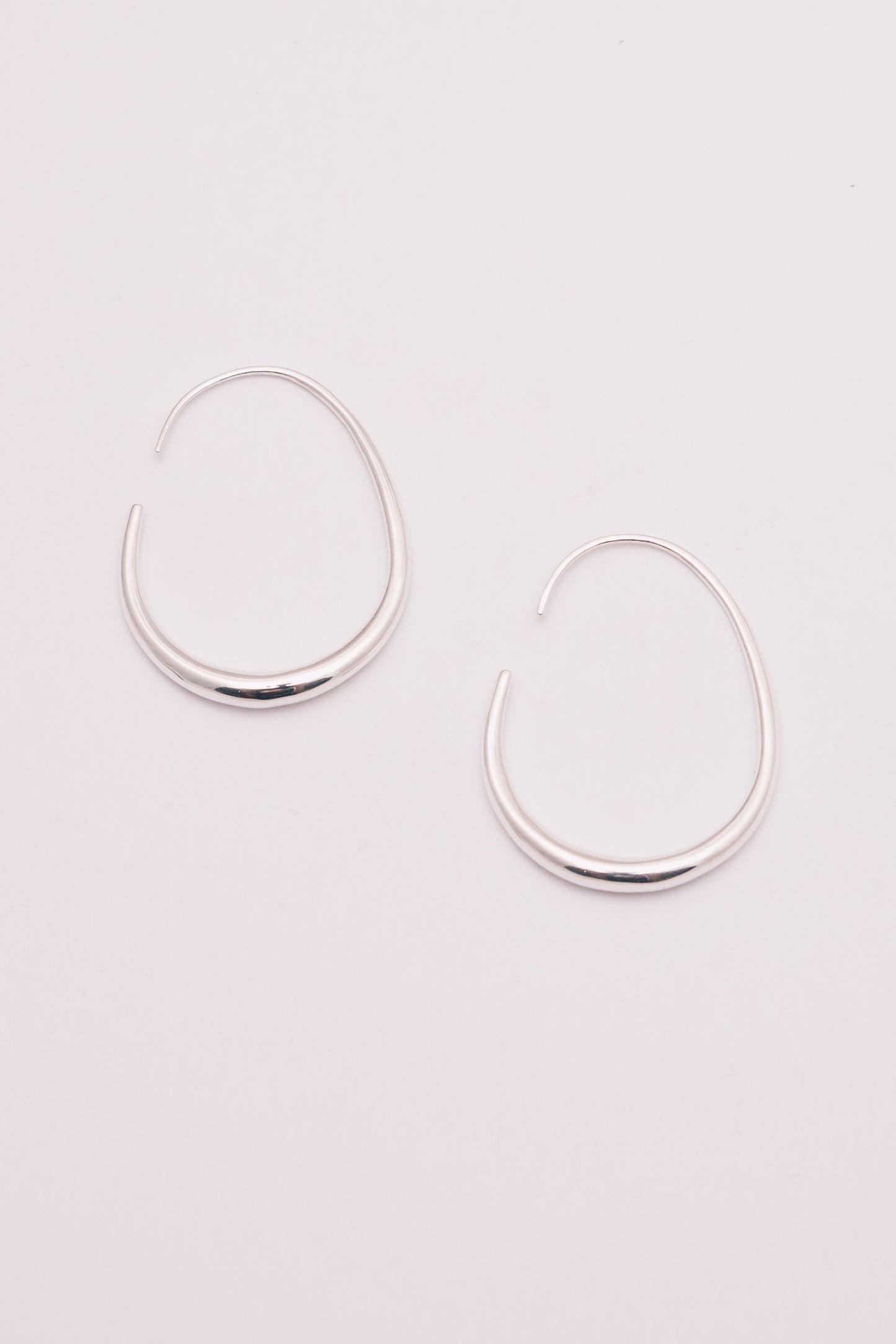 silver threader hoop earrings on white background